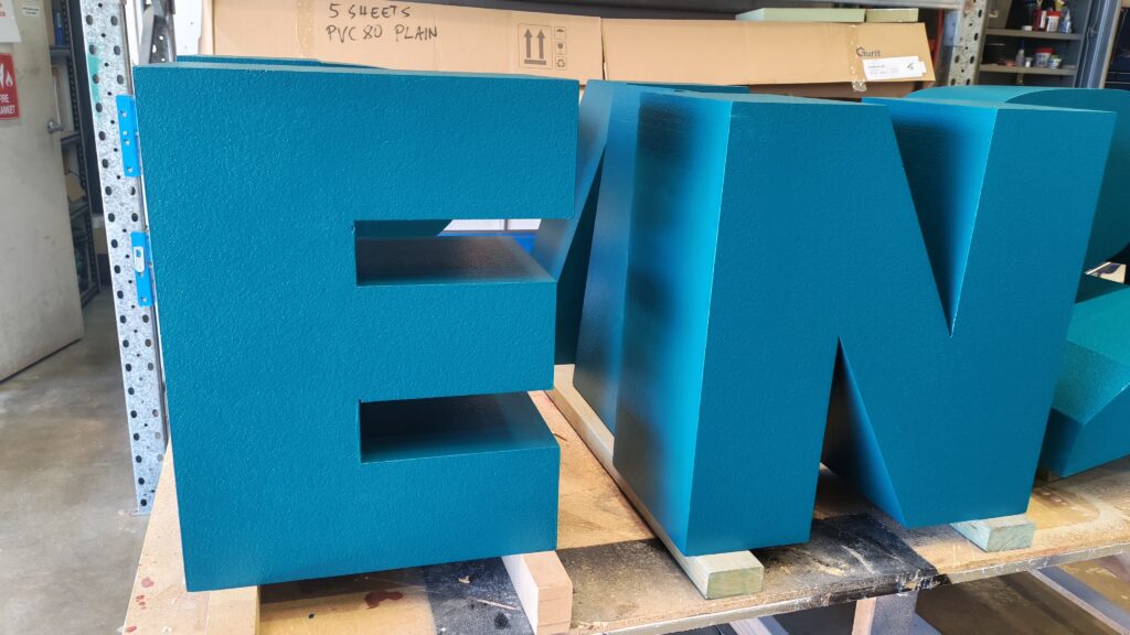 Blue dimensional foam lettering in the workshop