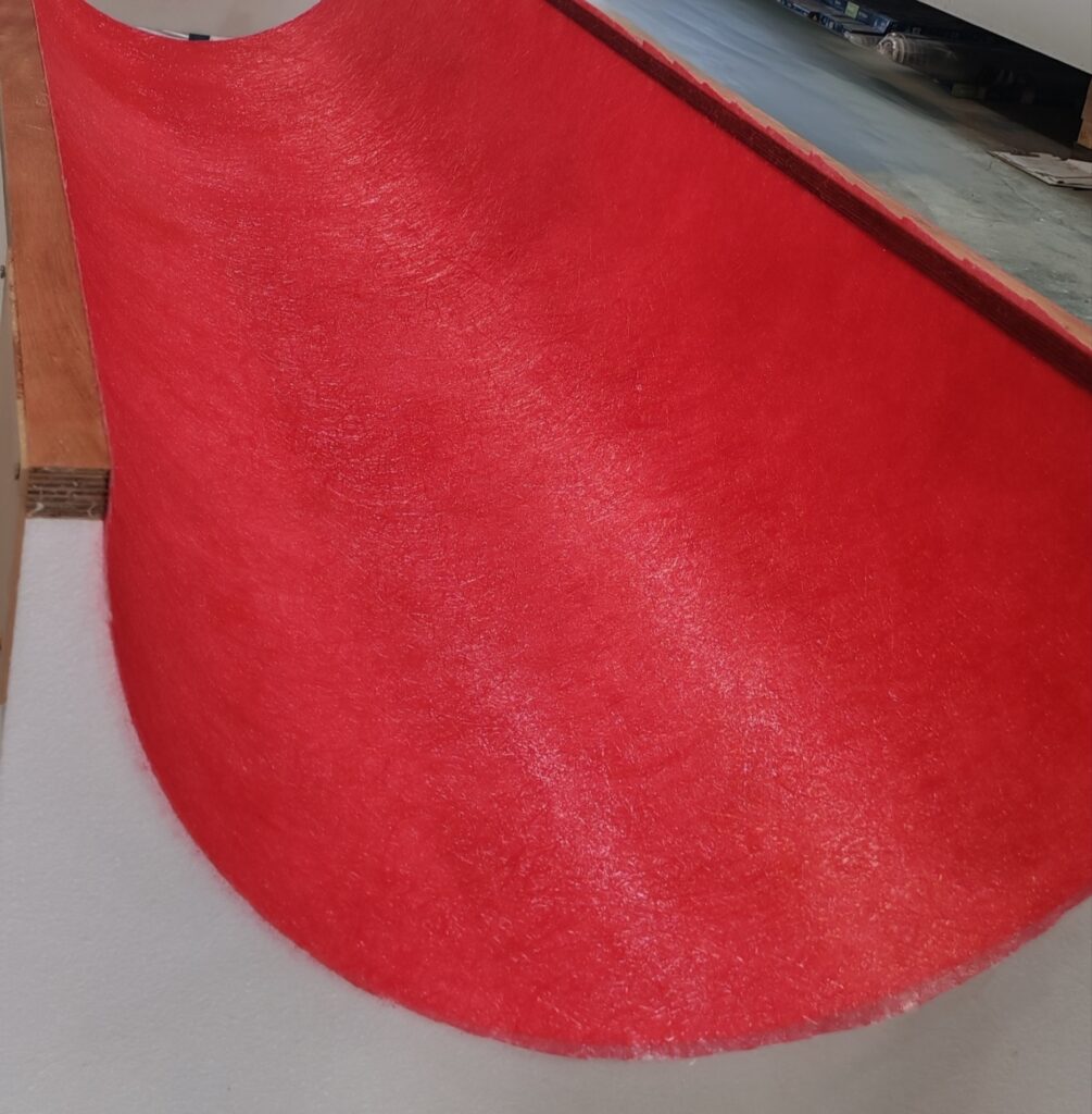 Curved foam profile with a red surface finish